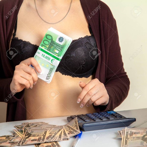61765380-woman-wtih-a-lot-of-money-in-hands-and-calculator-on-the-table.jpg